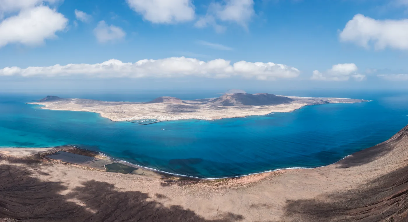 La Graciosa seen from high above across turquoise water, from the Mirador del Río on Lanzarote.
